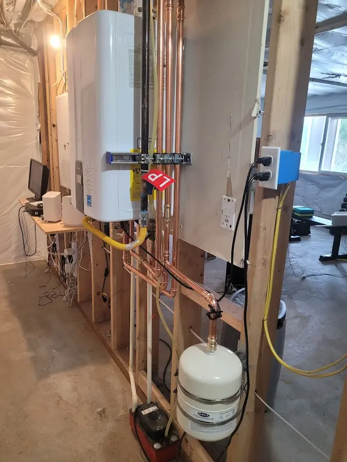 Licensed plumber repairing a kitchen sink in Conewago